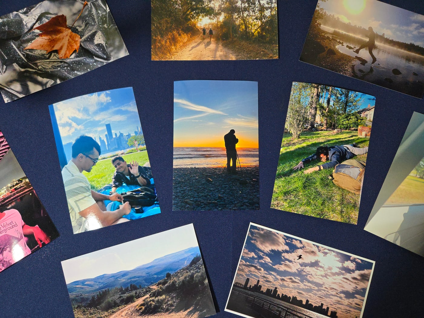 A spread of Ahmed's printed photographs on a dark surface